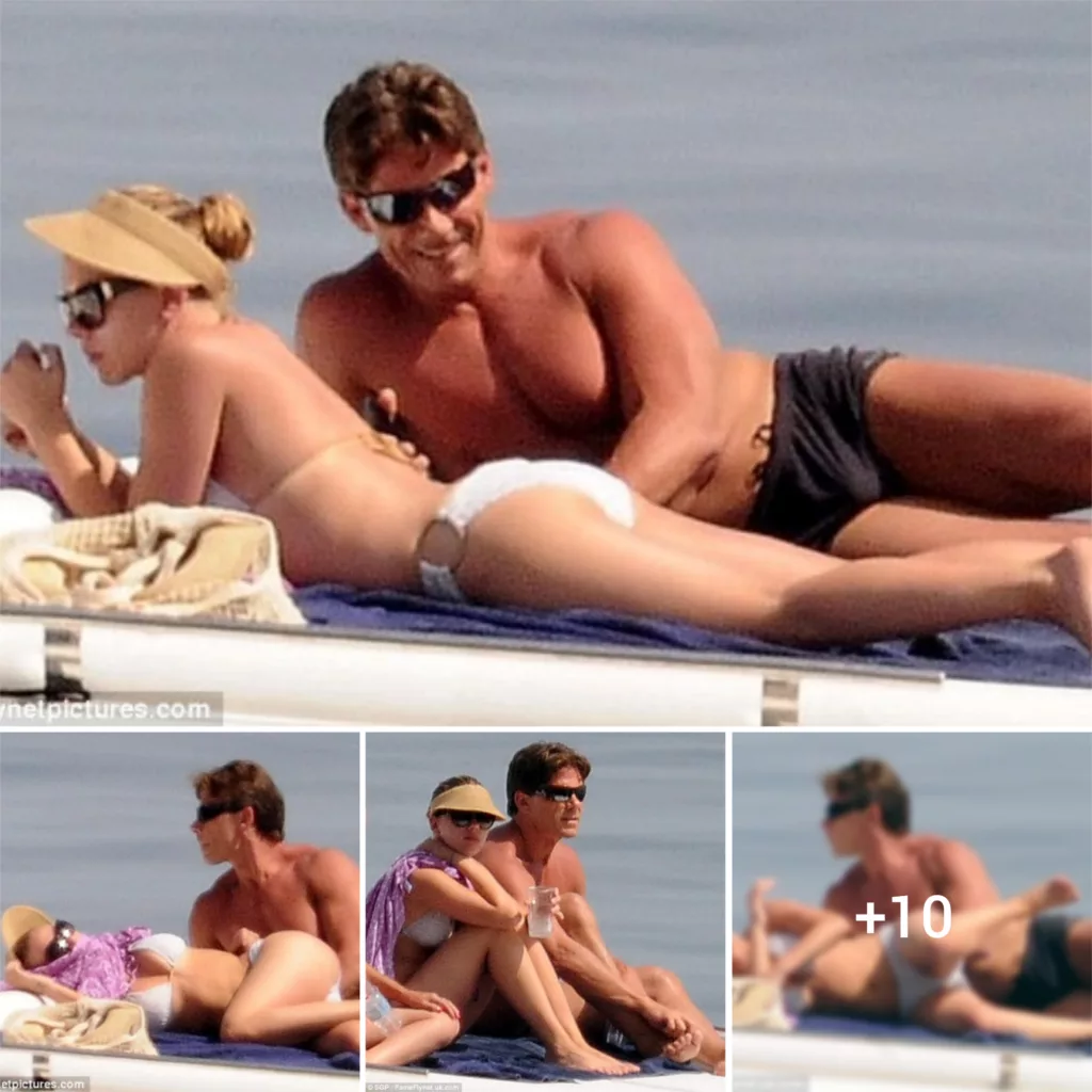 You call that work! Scarlett Johansson’s bodyguard keeps her under very close surveillance… as she sunbathes in a white bikini